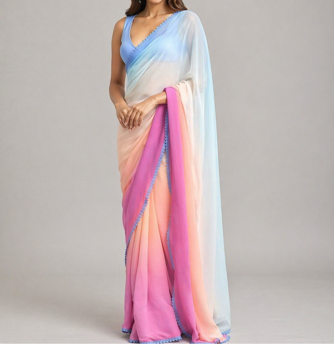 Woman wearing a colorful saree with a gradient design on a plain background
