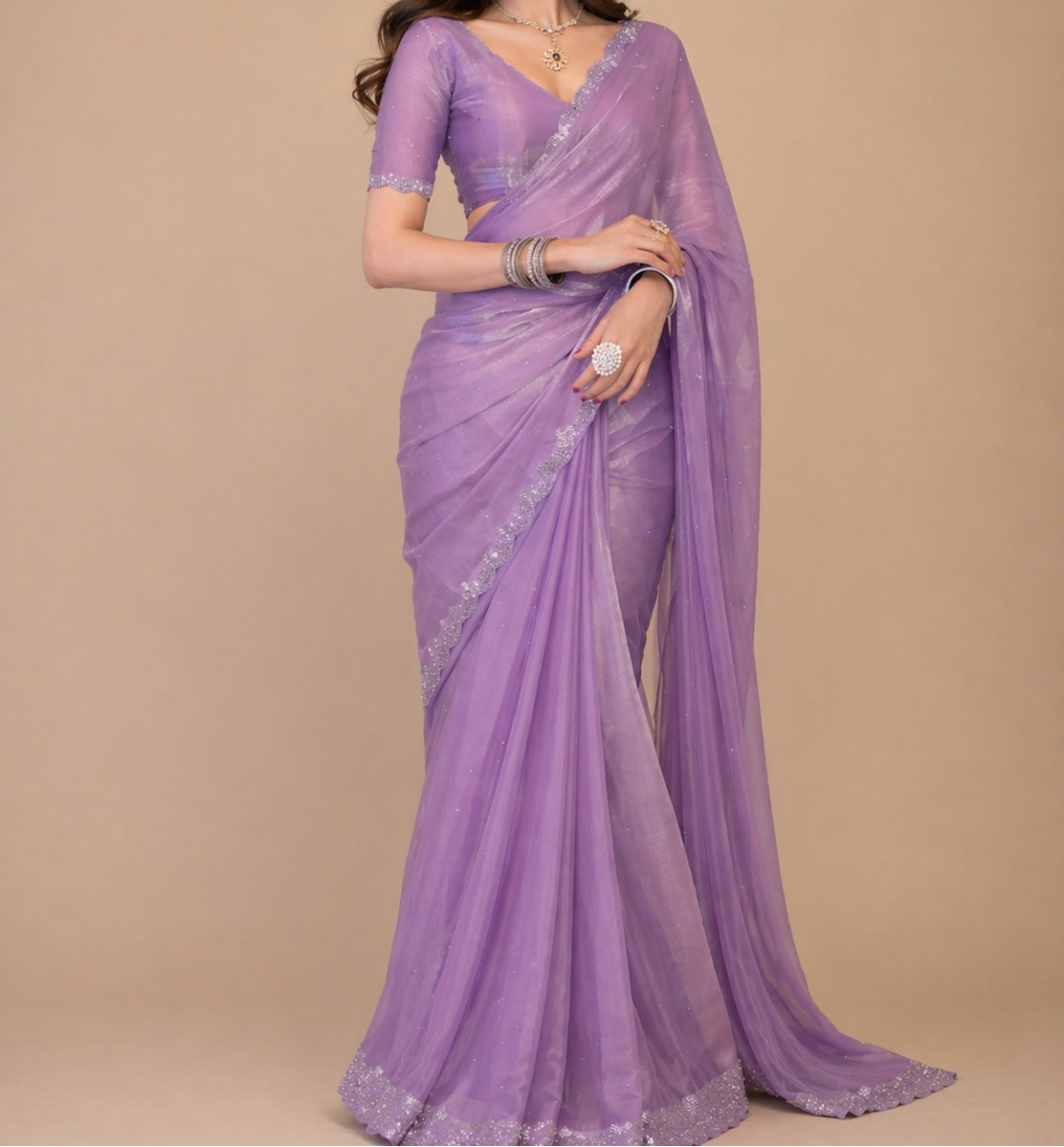 Woman wearing a purple saree with a beige background