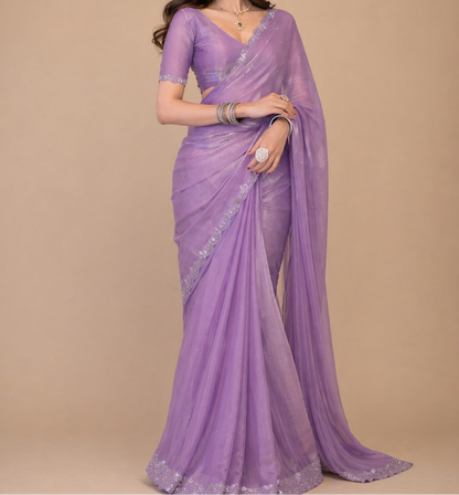 Woman wearing a purple saree with a beige background
